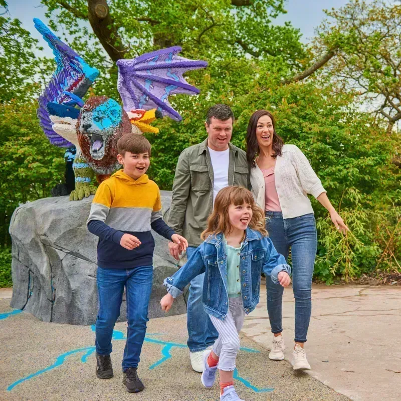 Family in front of LEGO Chimera model